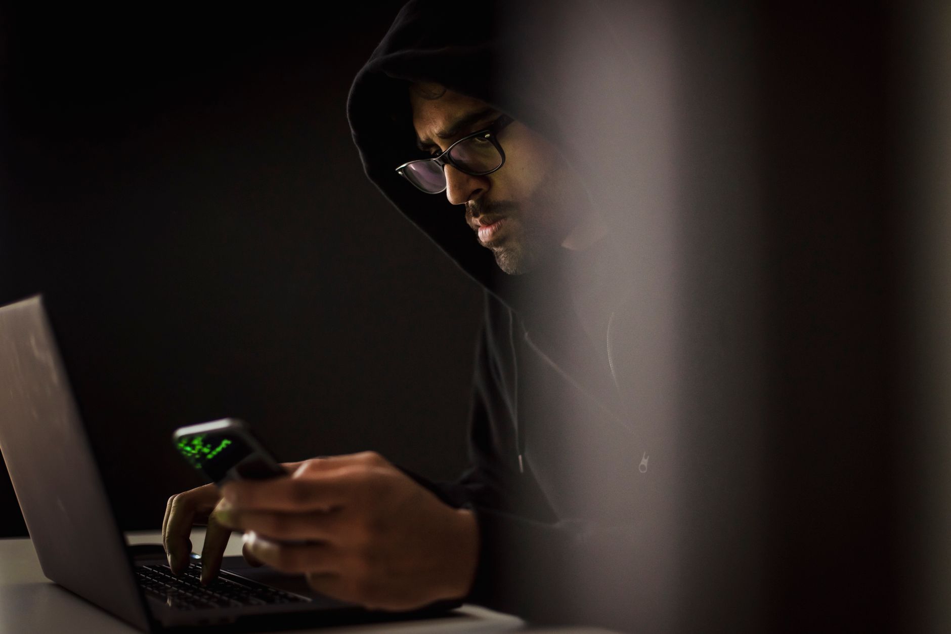 Anonymous hacker figure at monitors in a crypto drainer scam UK HMRC FCA campaign setup