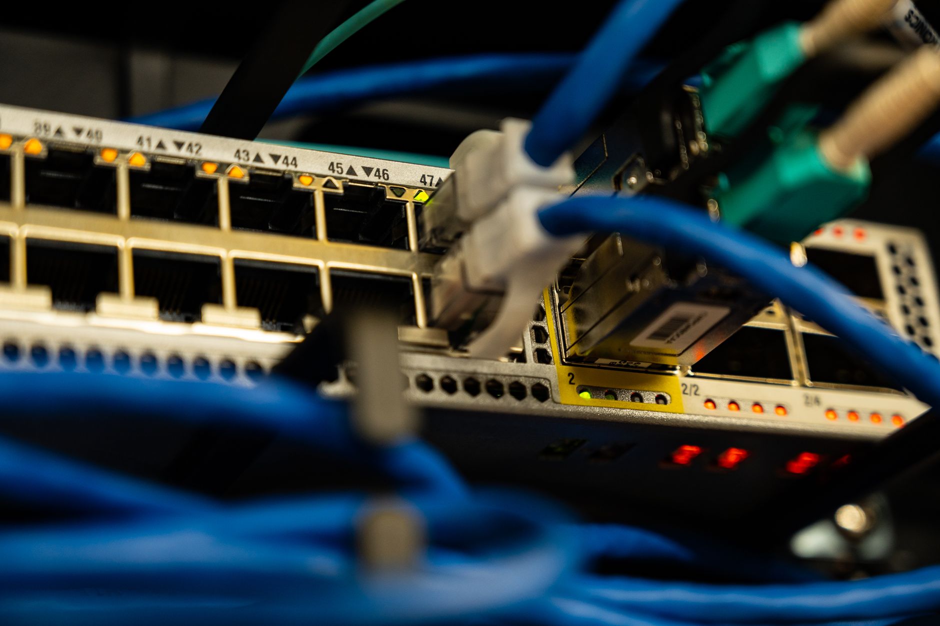 Dark server rack and cables representing the DCC relay infrastructure in the SMETS2 smart meter architecture
