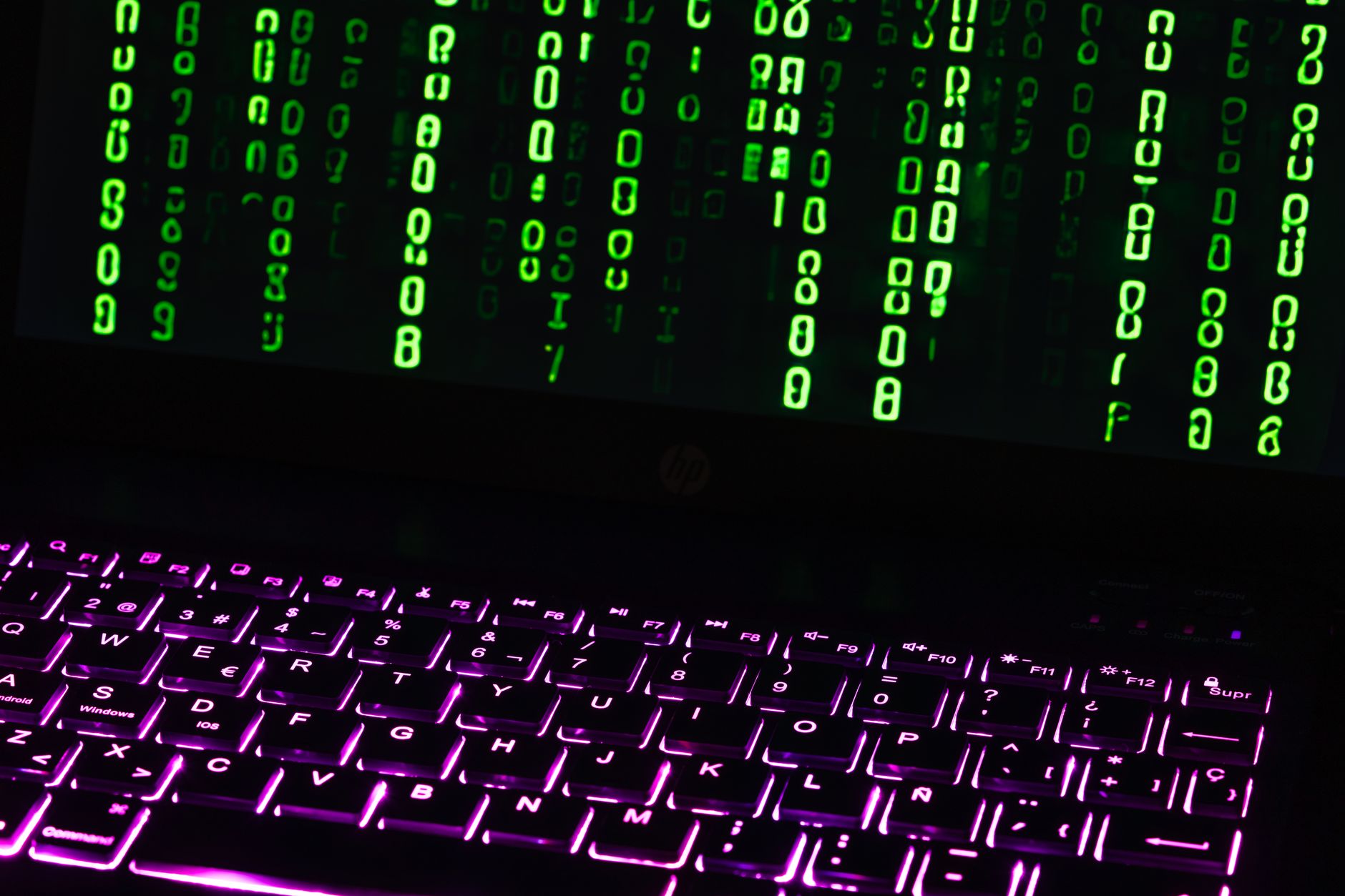 Researcher in dark room reviewing code related to NCSC vulnerability disclosure UK process
