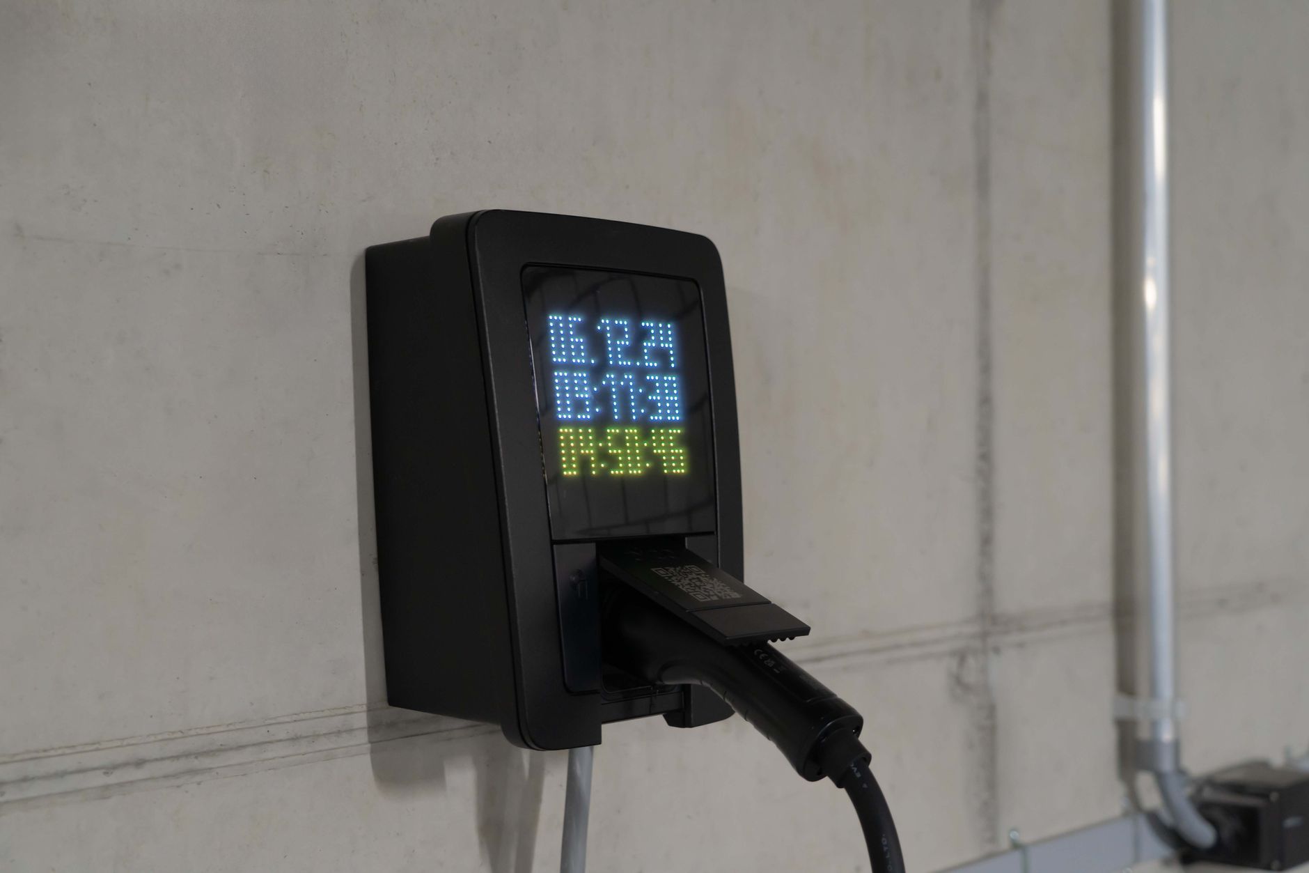 Insurer telematics black box plugged into OBD port under car dashboard