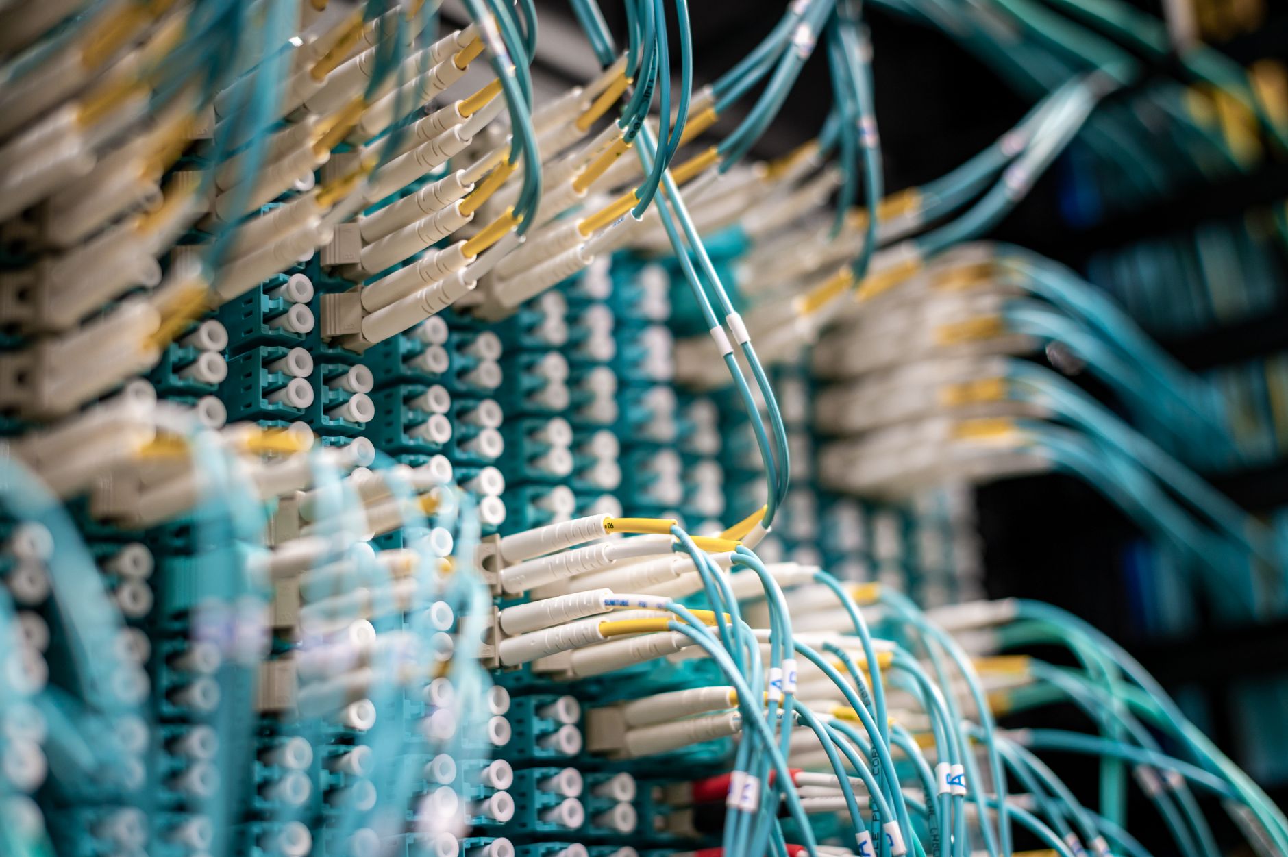 Server rack and network cables in a dark data centre, representing council CCTV network security infrastructure